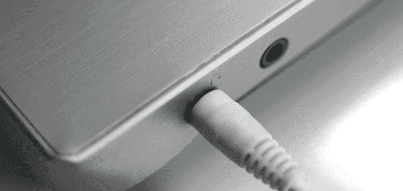 headphone jack plugged into laptop